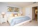 Bedroom with a bed featuring bedside tables and modern paintings at 2928 Buccaneer Palm Rd, Kissimmee, FL 34747