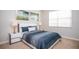 This bedroom features a window with blinds, two framed pictures, and lamps on the two end tables at 2928 Buccaneer Palm Rd, Kissimmee, FL 34747