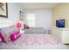 Spacious bedroom with two beds, a white dresser, and a television at 2928 Buccaneer Palm Rd, Kissimmee, FL 34747