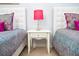 Bedroom featuring two beds separated by a nightstand with a pink polka dot lamp at 2928 Buccaneer Palm Rd, Kissimmee, FL 34747