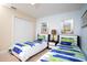 Cozy bedroom with twin beds, wall art, closet, and a ceiling fan at 2928 Buccaneer Palm Rd, Kissimmee, FL 34747
