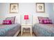 Bright bedroom featuring two twin beds with colorful bedding and fun artwork at 2928 Buccaneer Palm Rd, Kissimmee, FL 34747