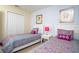 Well-lit bedroom featuring two beds with white headboards and closet at 2928 Buccaneer Palm Rd, Kissimmee, FL 34747