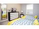 Comfortable bedroom featuring two twin beds, dresser with TV, and a large mirror at 2928 Buccaneer Palm Rd, Kissimmee, FL 34747