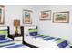 Close-up of a bedroom featuring twin beds, colorful wall art and coordinated decor at 2928 Buccaneer Palm Rd, Kissimmee, FL 34747