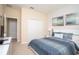 This bedroom features a window with blinds, two framed pictures, lamps on two end tables, and a closet at 2928 Buccaneer Palm Rd, Kissimmee, FL 34747