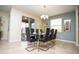 Contemporary dining room with a glass table, modern chairs, and stylish chandelier at 2928 Buccaneer Palm Rd, Kissimmee, FL 34747