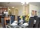 Elegant dining room with seating for eight adjacent to the kitchen and living spaces at 2928 Buccaneer Palm Rd, Kissimmee, FL 34747
