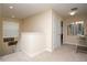 Bright upstairs hallway featuring neutral carpeting, modern decor, and access to multiple rooms at 2928 Buccaneer Palm Rd, Kissimmee, FL 34747