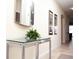 Hallway with a glass-topped table and stylish mirror and artwork at 2928 Buccaneer Palm Rd, Kissimmee, FL 34747