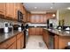 Well-lit kitchen with stainless steel appliances, granite countertops, and light wood cabinets at 2928 Buccaneer Palm Rd, Kissimmee, FL 34747