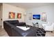 Comfortable living room with a large sectional sofa, patterned rug, and modern artwork at 2928 Buccaneer Palm Rd, Kissimmee, FL 34747
