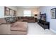 Comfortable living room featuring a large sectional sofa, flat-screen TV, and neutral decor at 2928 Buccaneer Palm Rd, Kissimmee, FL 34747