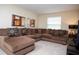 Inviting living room with plush sectional sofa, neutral carpeting, and modern decor at 2928 Buccaneer Palm Rd, Kissimmee, FL 34747
