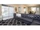 Inviting living room with access to the patio and dining area, featuring a black patterned rug at 2928 Buccaneer Palm Rd, Kissimmee, FL 34747