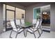 Covered patio area with a table and chairs, perfect for outdoor dining and entertaining at 2928 Buccaneer Palm Rd, Kissimmee, FL 34747