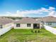 Spacious backyard featuring a well-maintained lawn and privacy fence at 29746 Anahid Dr, Leesburg, FL 34748