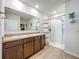 This spacious bathroom boasts a double sink vanity, shower, and linen closet at 29746 Anahid Dr, Leesburg, FL 34748