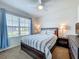 This cozy bedroom features a ceiling fan, a comfortable bed, and a sunny window at 29746 Anahid Dr, Leesburg, FL 34748