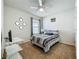 This well-lit bedroom features a ceiling fan, a comfortable bed, and a sunny window at 29746 Anahid Dr, Leesburg, FL 34748