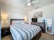 This serene bedroom features a comfortable bed, ceiling fan, and a beautiful painting at 29746 Anahid Dr, Leesburg, FL 34748