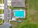 Aerial view of a community pool with lounge chairs and a well-kept surrounding landscape at 29746 Anahid Dr, Leesburg, FL 34748