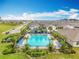 Upscale community pool surrounded by lush landscaping and ample lounge seating at 29746 Anahid Dr, Leesburg, FL 34748
