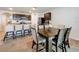 Open-concept kitchen featuring dark wood cabinetry, granite countertops, and stainless steel appliances adjacent to dining area at 29746 Anahid Dr, Leesburg, FL 34748
