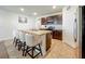 Well-lit kitchen features an island with barstool seating and stainless steel appliances at 29746 Anahid Dr, Leesburg, FL 34748