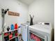 Bright laundry room featuring a white washer and dryer set at 29746 Anahid Dr, Leesburg, FL 34748