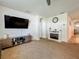 Cozy living area with fireplace, modern furnishings, and neutral carpeting at 29746 Anahid Dr, Leesburg, FL 34748