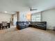 Comfortable living room with modern furnishings, including a large sectional sofa and dining area at 29746 Anahid Dr, Leesburg, FL 34748