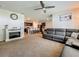 Inviting living room with view to the kitchen, a fireplace, and a comfortable leather sofa at 29746 Anahid Dr, Leesburg, FL 34748