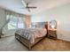 This serene bedroom features a ceiling fan and large window for ample natural light at 29746 Anahid Dr, Leesburg, FL 34748