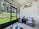 Inviting screened patio featuring comfortable seating and a serene backyard view at 29746 Anahid Dr, Leesburg, FL 34748