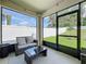 Relaxing screened patio featuring a modern patio set and view of fenced yard at 29746 Anahid Dr, Leesburg, FL 34748