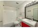 Bathroom with white tiling, a shower-tub combo and a red vanity at 3034 Parkway Blvd # 102, Kissimmee, FL 34747