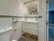 Bathroom with a double sink, textured tile, and a modern medicine cabinet at 3034 Parkway Blvd # 102, Kissimmee, FL 34747