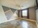 Modern bedroom with gray accent wall, polished concrete floors, and ceiling fan at 3034 Parkway Blvd # 102, Kissimmee, FL 34747