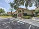 Exterior view of the community clubhouse with well-maintained landscaping and parking at 3034 Parkway Blvd # 102, Kissimmee, FL 34747