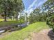Scenic community view with a pond, fountain, mature trees, and green spaces at 3034 Parkway Blvd # 102, Kissimmee, FL 34747
