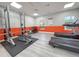 Community gym showcasing weight-lifting machines, a bench, and treadmills with plank floors at 3034 Parkway Blvd # 102, Kissimmee, FL 34747