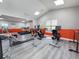 Community gym showcasing several cardio machines with a clean, gray plank floor at 3034 Parkway Blvd # 102, Kissimmee, FL 34747