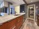 Modern kitchen featuring granite countertops, stainless steel appliances and stackable washer and dryer at 3034 Parkway Blvd # 102, Kissimmee, FL 34747