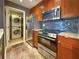 Modern kitchen with stainless steel appliances, granite countertop and a stacked washer/dryer at 3034 Parkway Blvd # 102, Kissimmee, FL 34747