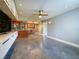 Open-concept living room featuring modern lighting, polished concrete floors, and an adjacent kitchen at 3034 Parkway Blvd # 102, Kissimmee, FL 34747