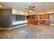 Spacious living room with ceiling fan, TV, and modern cabinets overlooking open kitchen at 3034 Parkway Blvd # 102, Kissimmee, FL 34747