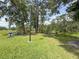Community park area with picnic tables and lush green lawn next to the pond at 3034 Parkway Blvd # 102, Kissimmee, FL 34747