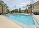 Community pool featuring a refreshing blue color with lots of lounge seating and palm trees at 3034 Parkway Blvd # 102, Kissimmee, FL 34747