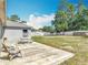 Large backyard featuring a concrete patio, green grass, and a white privacy fence at 3130 Clewiston St, Deltona, FL 32738